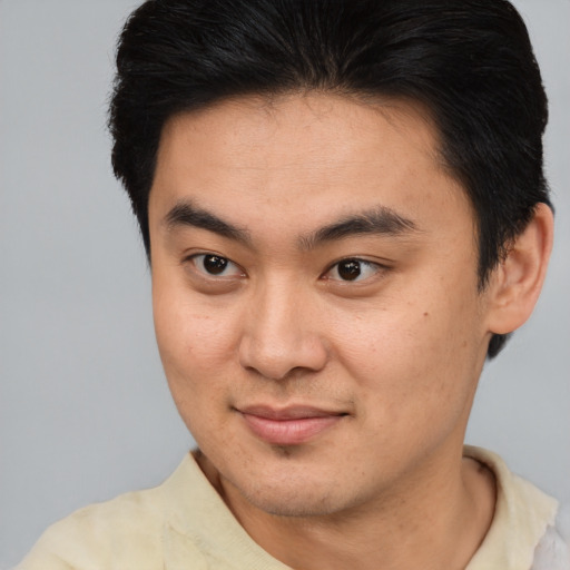 Joyful asian young-adult male with short  brown hair and brown eyes