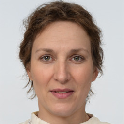 Joyful white adult female with medium  brown hair and grey eyes