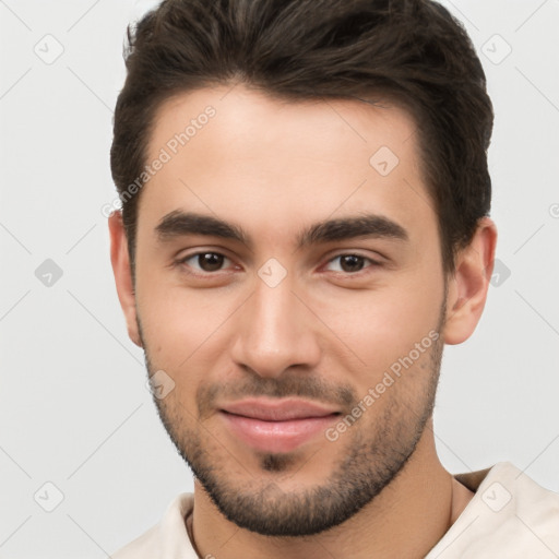 Joyful white young-adult male with short  brown hair and brown eyes