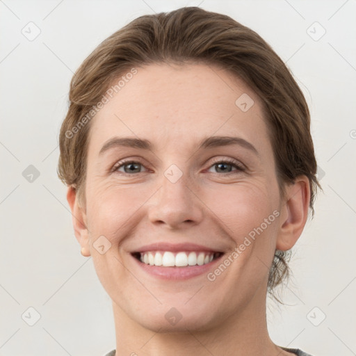 Joyful white young-adult female with short  brown hair and grey eyes