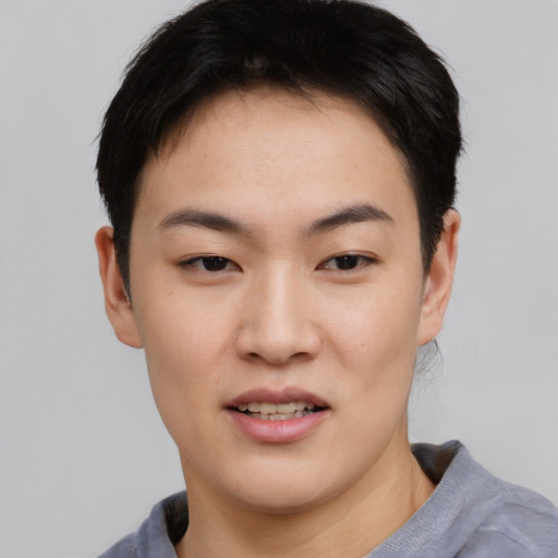 Joyful asian young-adult female with short  black hair and brown eyes