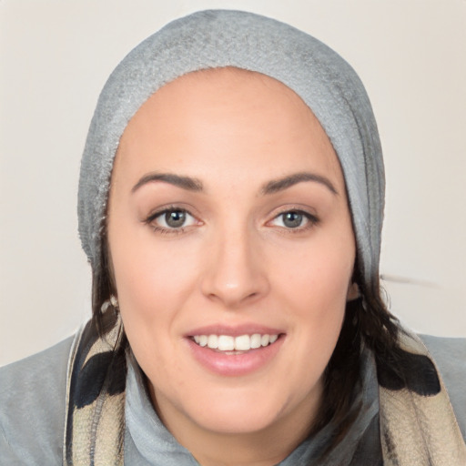 Joyful white young-adult female with long  black hair and brown eyes