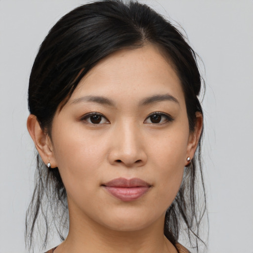 Joyful asian young-adult female with medium  brown hair and brown eyes