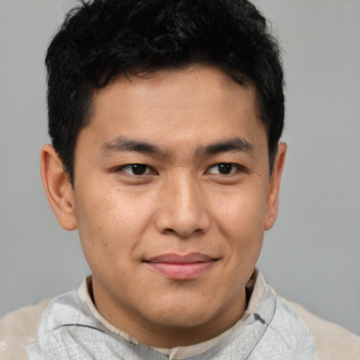 Joyful asian young-adult male with short  brown hair and brown eyes