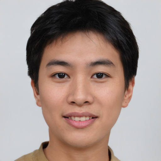 Joyful asian young-adult male with short  brown hair and brown eyes