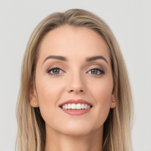 Joyful white young-adult female with long  brown hair and grey eyes