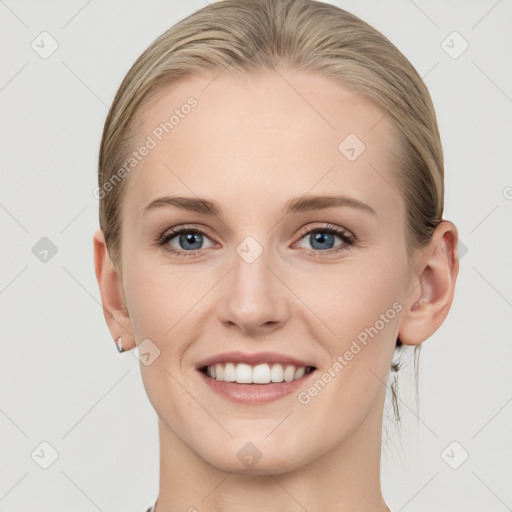 Joyful white young-adult female with medium  brown hair and blue eyes