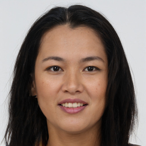Joyful asian young-adult female with long  brown hair and brown eyes