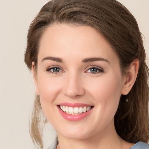 Joyful white young-adult female with medium  brown hair and grey eyes