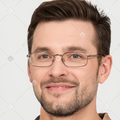 Joyful white adult male with short  brown hair and brown eyes