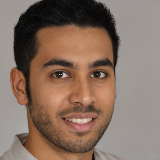 Joyful latino young-adult male with short  brown hair and brown eyes