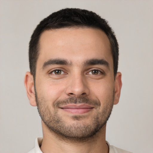 Joyful white young-adult male with short  brown hair and brown eyes