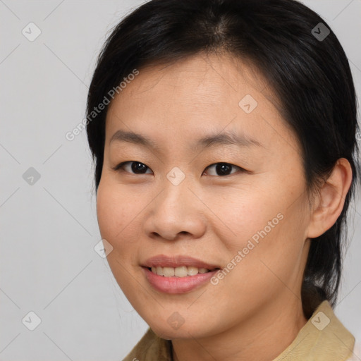 Joyful asian young-adult female with long  brown hair and brown eyes