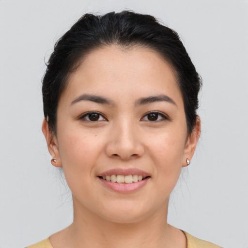 Joyful asian young-adult female with medium  brown hair and brown eyes