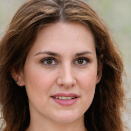 Joyful white young-adult female with long  brown hair and green eyes