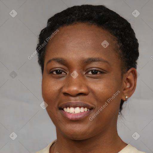 Joyful black young-adult female with short  brown hair and brown eyes