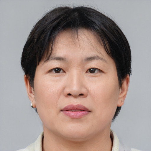 Joyful asian adult female with short  brown hair and brown eyes