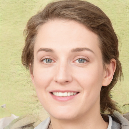 Joyful white young-adult female with medium  brown hair and green eyes