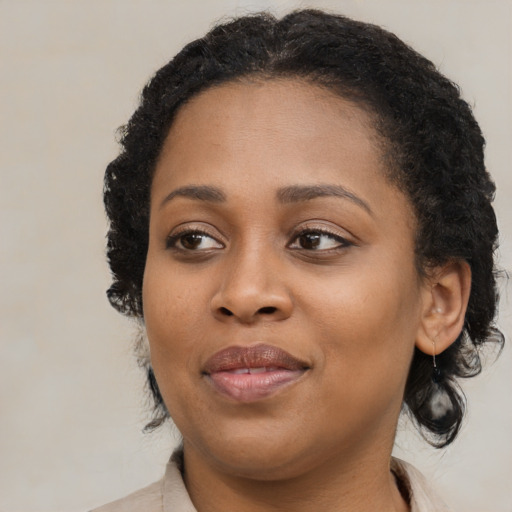 Joyful black young-adult female with medium  brown hair and brown eyes