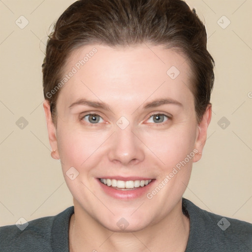 Joyful white young-adult female with short  brown hair and grey eyes