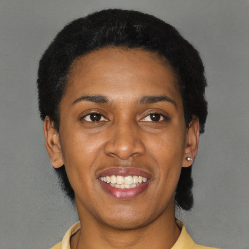 Joyful latino young-adult female with short  black hair and brown eyes