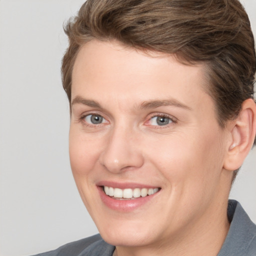 Joyful white adult female with medium  brown hair and grey eyes