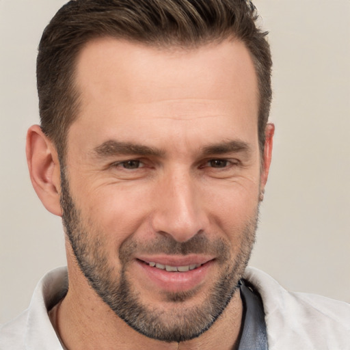 Joyful white adult male with short  brown hair and brown eyes