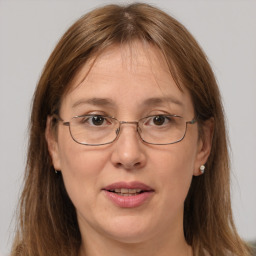 Joyful white adult female with long  brown hair and brown eyes