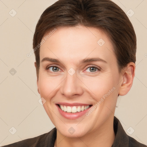 Joyful white young-adult female with short  brown hair and grey eyes