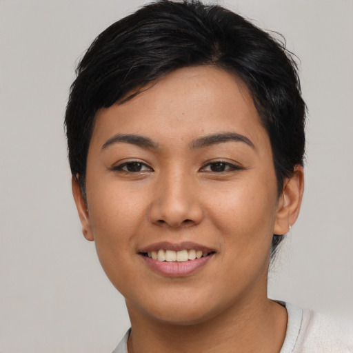 Joyful asian young-adult female with short  black hair and brown eyes