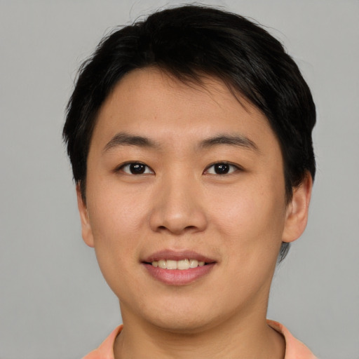 Joyful asian young-adult male with short  brown hair and brown eyes