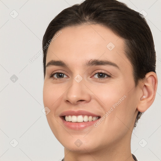 Joyful white young-adult female with short  brown hair and brown eyes