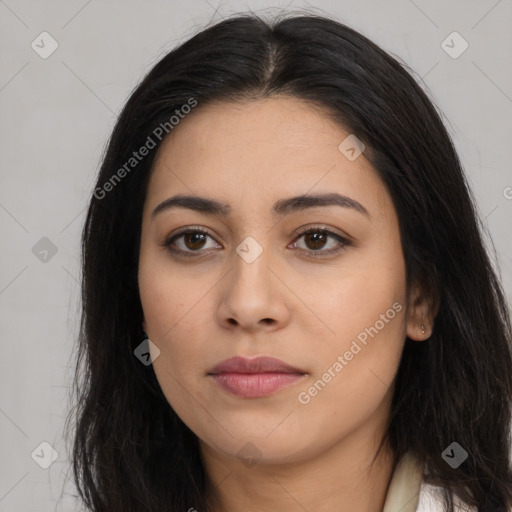 Joyful latino young-adult female with long  brown hair and brown eyes