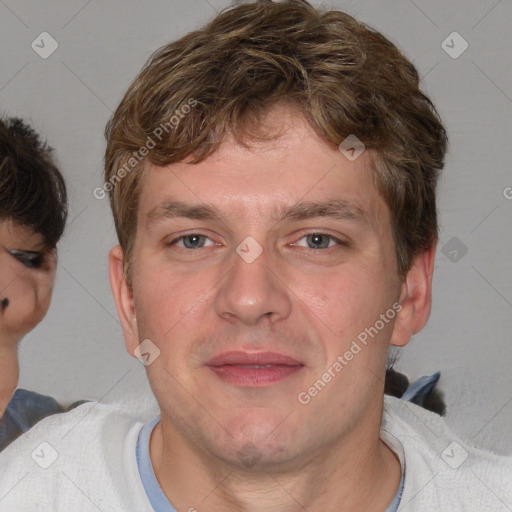 Joyful white adult male with short  brown hair and blue eyes