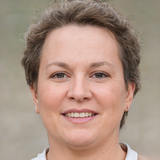 Joyful white adult female with short  brown hair and brown eyes