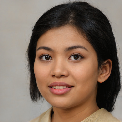 Joyful asian young-adult female with medium  black hair and brown eyes