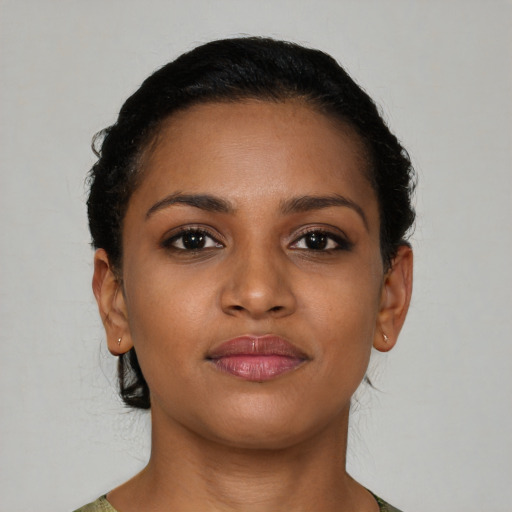 Joyful black young-adult female with short  brown hair and brown eyes
