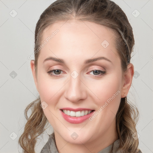 Joyful white young-adult female with long  brown hair and grey eyes