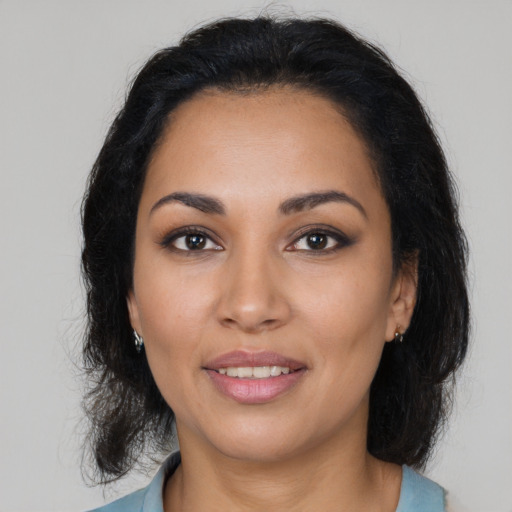 Joyful latino young-adult female with medium  brown hair and brown eyes