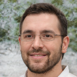 Joyful white adult male with short  brown hair and brown eyes