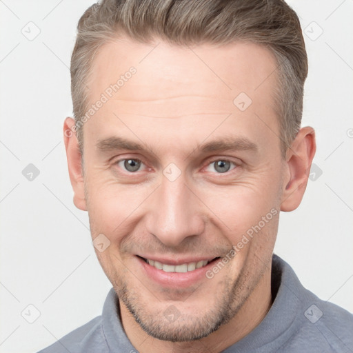 Joyful white adult male with short  brown hair and grey eyes