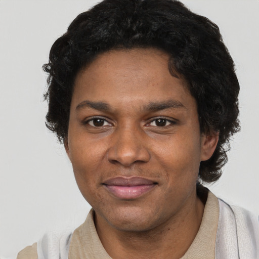 Joyful black young-adult male with short  brown hair and brown eyes