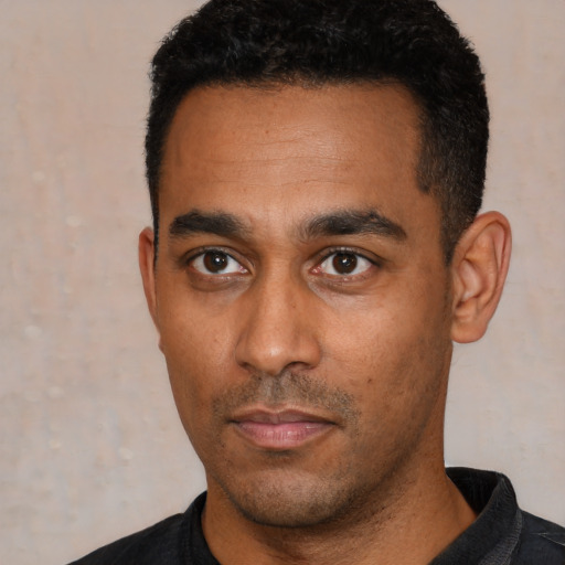 Neutral latino young-adult male with short  black hair and brown eyes