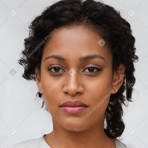 Joyful black young-adult female with long  brown hair and brown eyes