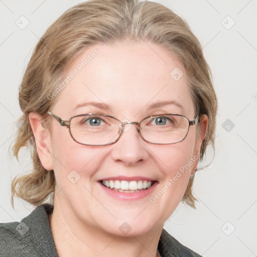 Joyful white adult female with medium  brown hair and blue eyes