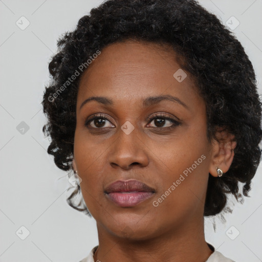 Joyful black adult female with short  brown hair and brown eyes