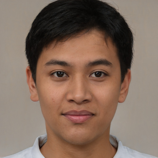 Joyful asian young-adult male with short  brown hair and brown eyes
