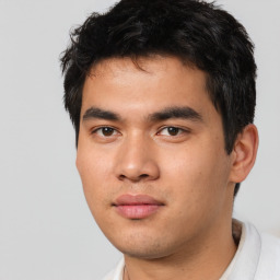 Joyful asian young-adult male with short  black hair and brown eyes