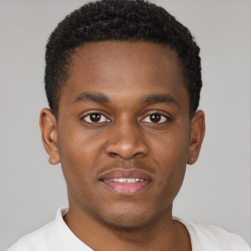 Joyful black young-adult male with short  brown hair and brown eyes