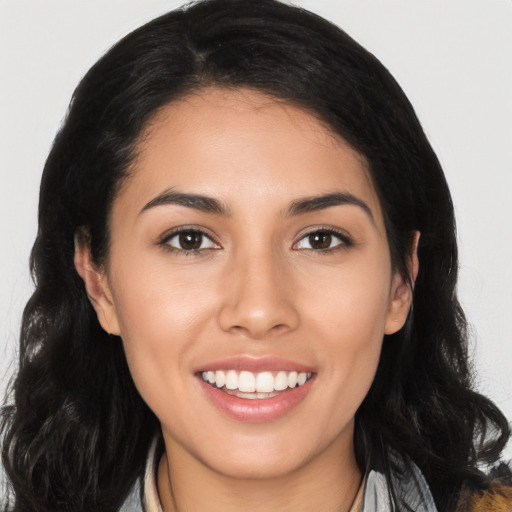 Joyful latino young-adult female with long  black hair and brown eyes